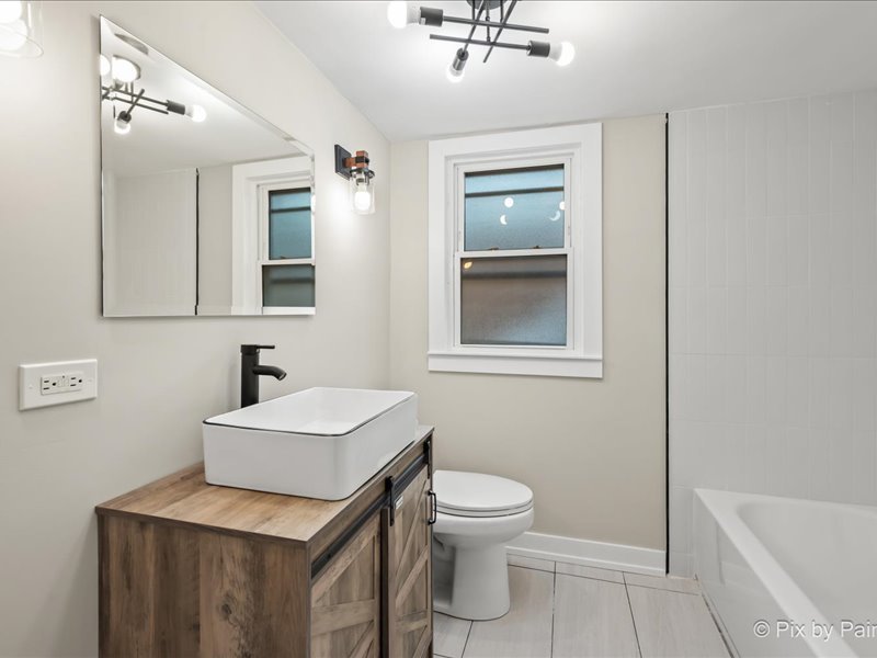 3922 West 59th Place Chicago, IL 60629 - Photo 14 of 29 a bathroom with a sink a toilet and shower