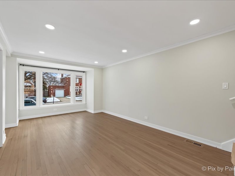 3922 West 59th Place Chicago, IL 60629 - Photo 4 of 29 a view of an empty room with wooden floor and a window