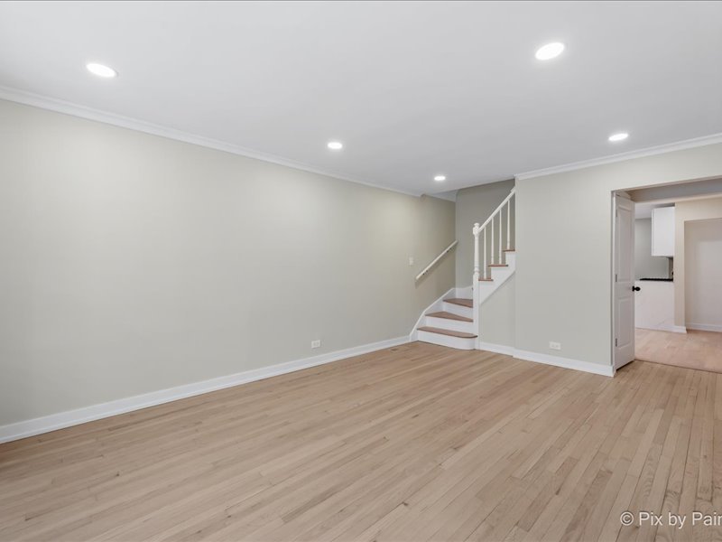 3922 West 59th Place Chicago, IL 60629 - Photo 5 of 29 an empty room with wooden floor and windows
