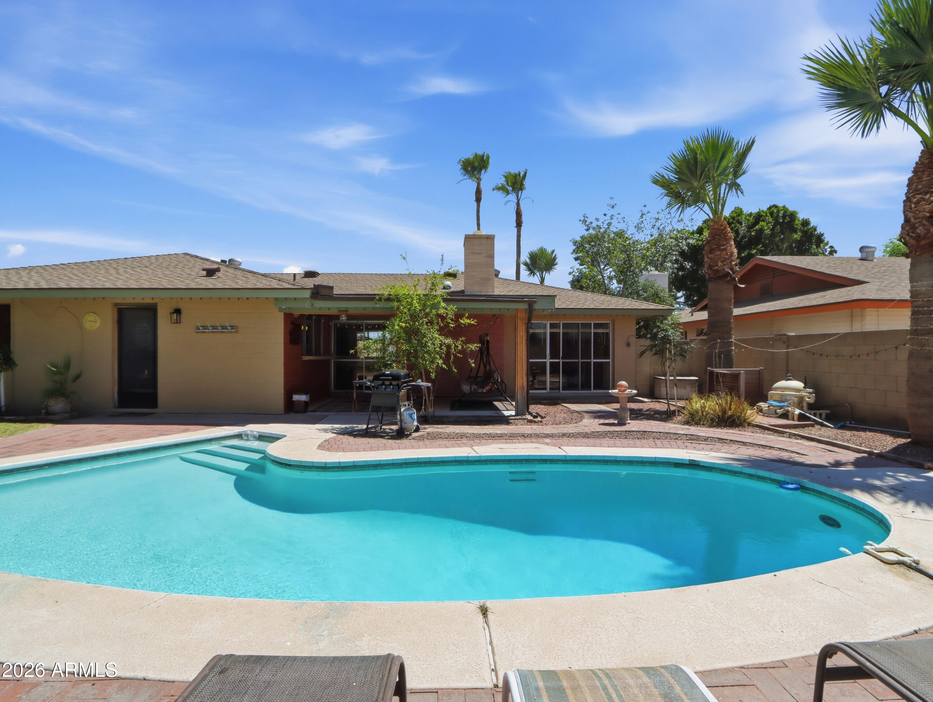 450 Cascada Road Litchfield Park, AZ 85340 - Photo 27 of 40 a view of a house with swimming pool and sitting area