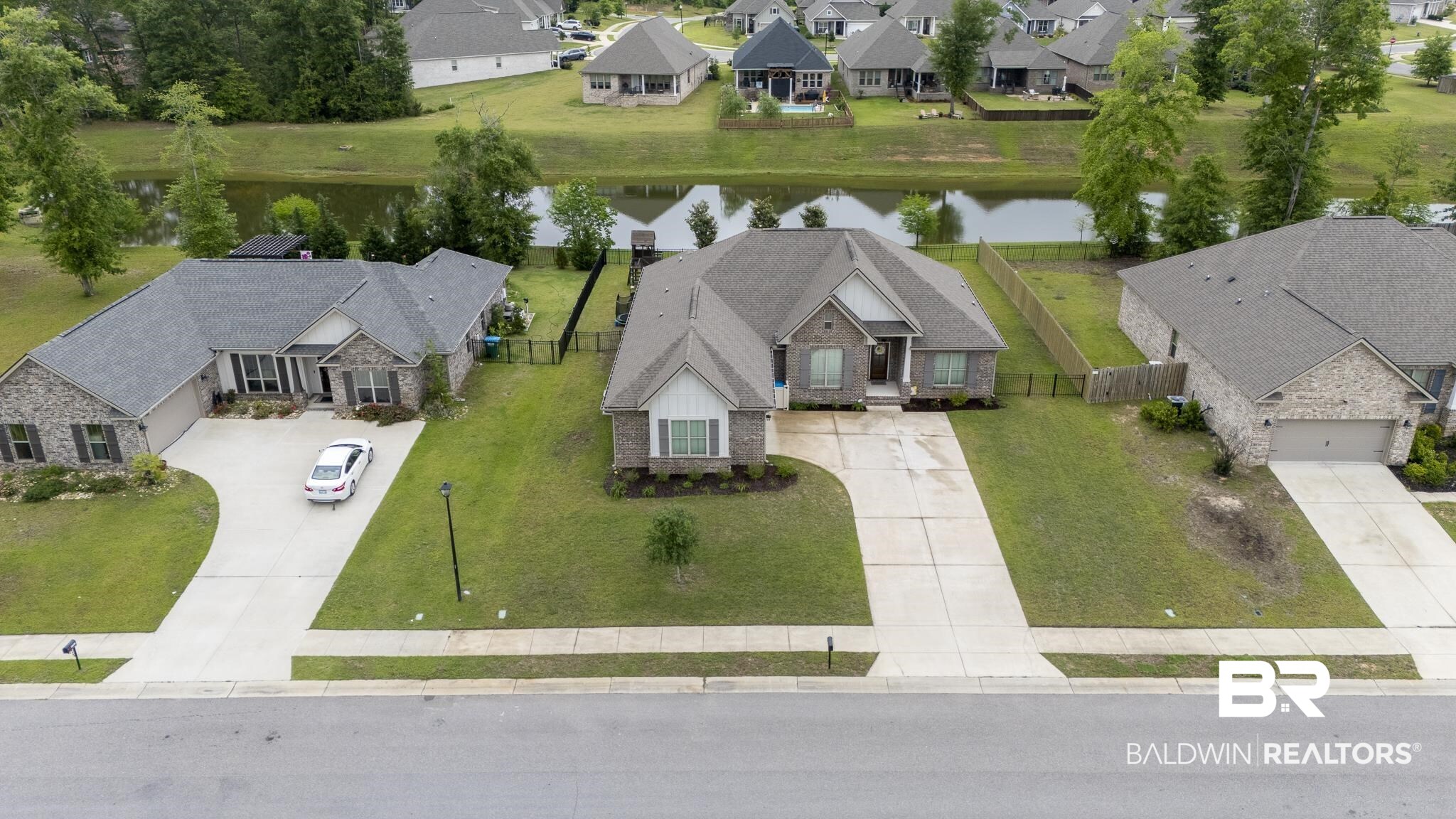 12672 Squirrel Drive Daphne, AL 36527 - Photo 42 of 49 Brick residence featuring a gabled roofline, concrete driveway, and a manicured front lawn
