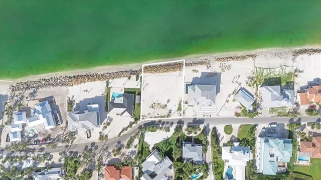 an aerial view of lake and residential houses with outdoor space