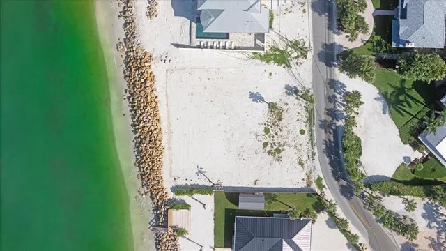a view of a dry yard with wooden fence