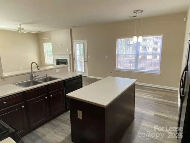a kitchen with a sink cabinets and a wooden floor