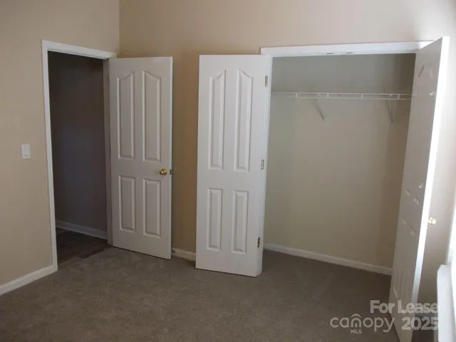 an empty room with closet area