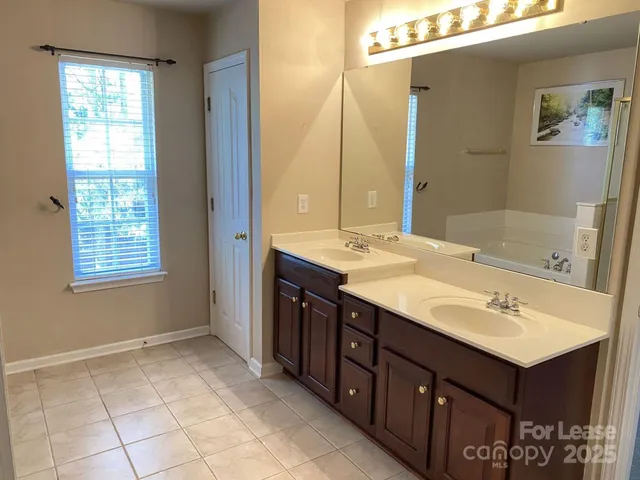 a bathroom with a sink vanity and mirror
