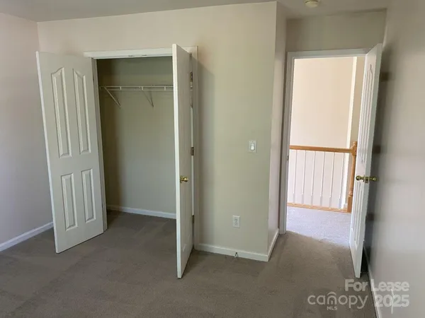 a view of an empty room with a fireplace