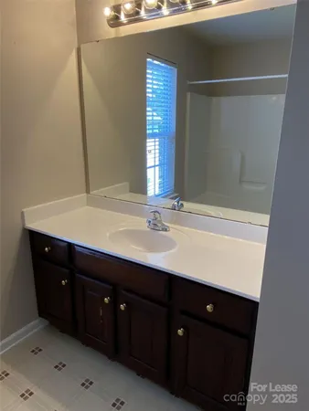 a bathroom with a sink vanity and mirror