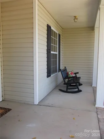 a view of backyard with furniture and a gate