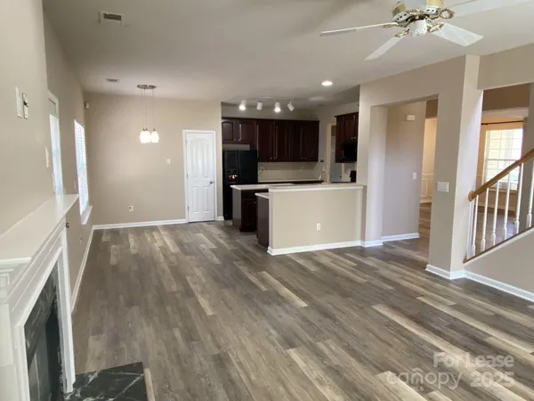 a view of kitchen with sink and refrigerator
