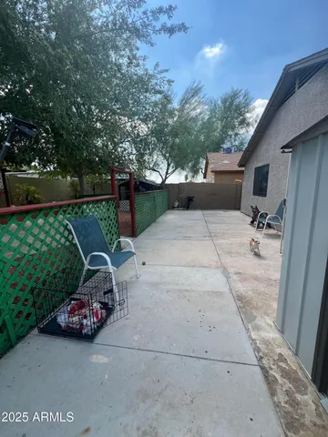 a view of a patio with table and chairs