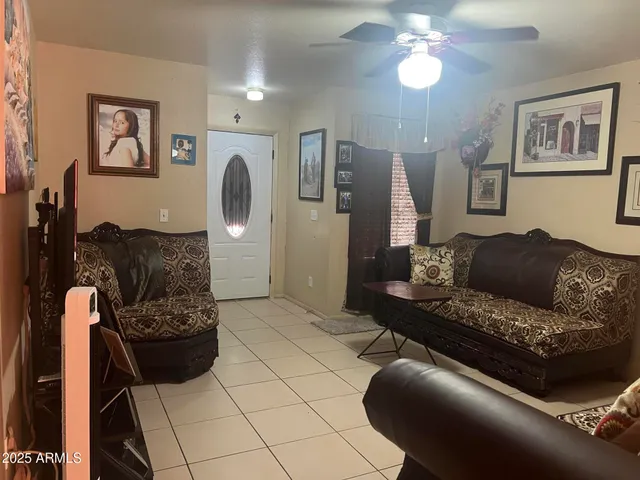 a living room with furniture and a chandelier