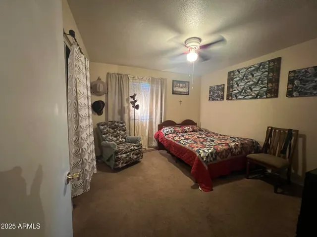 a bedroom with bed and a chandelier