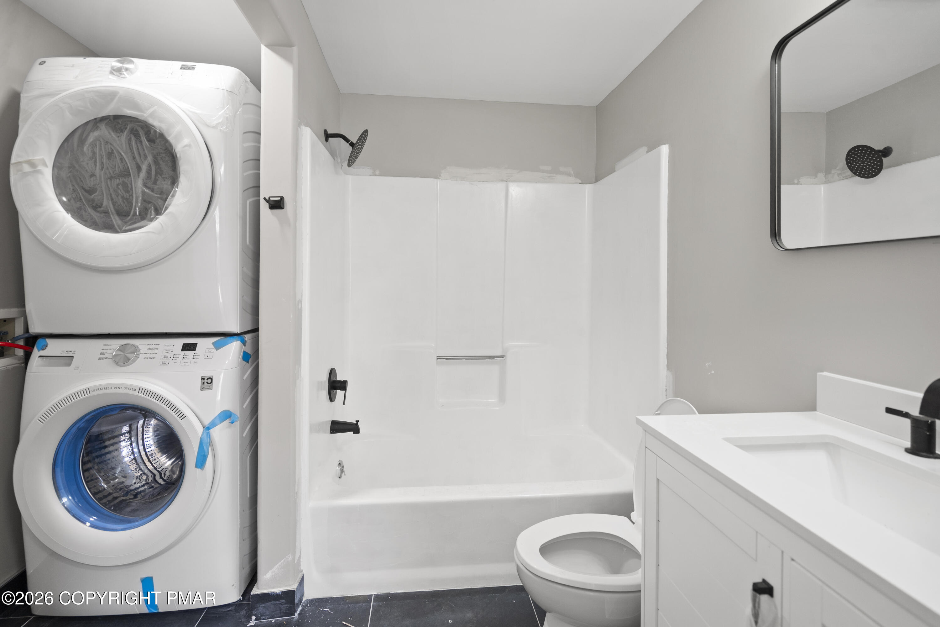 605 5th Street Matamoras, PA 18336 - Photo 20 of 27 a bathroom with a sink a washer and dryer