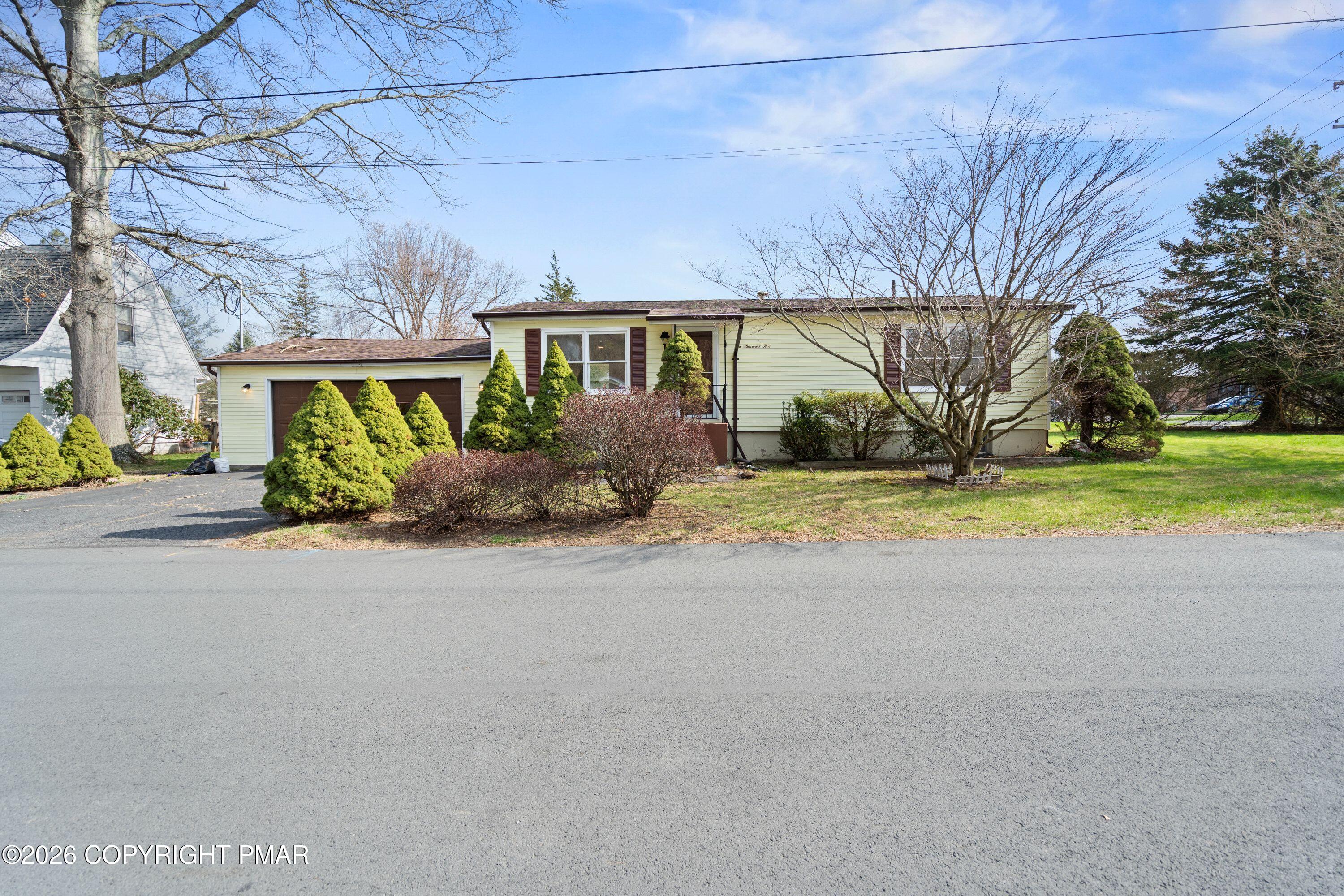 605 5th Street Matamoras, PA 18336 - Photo 4 of 27 a front view of a house with a yard and garage