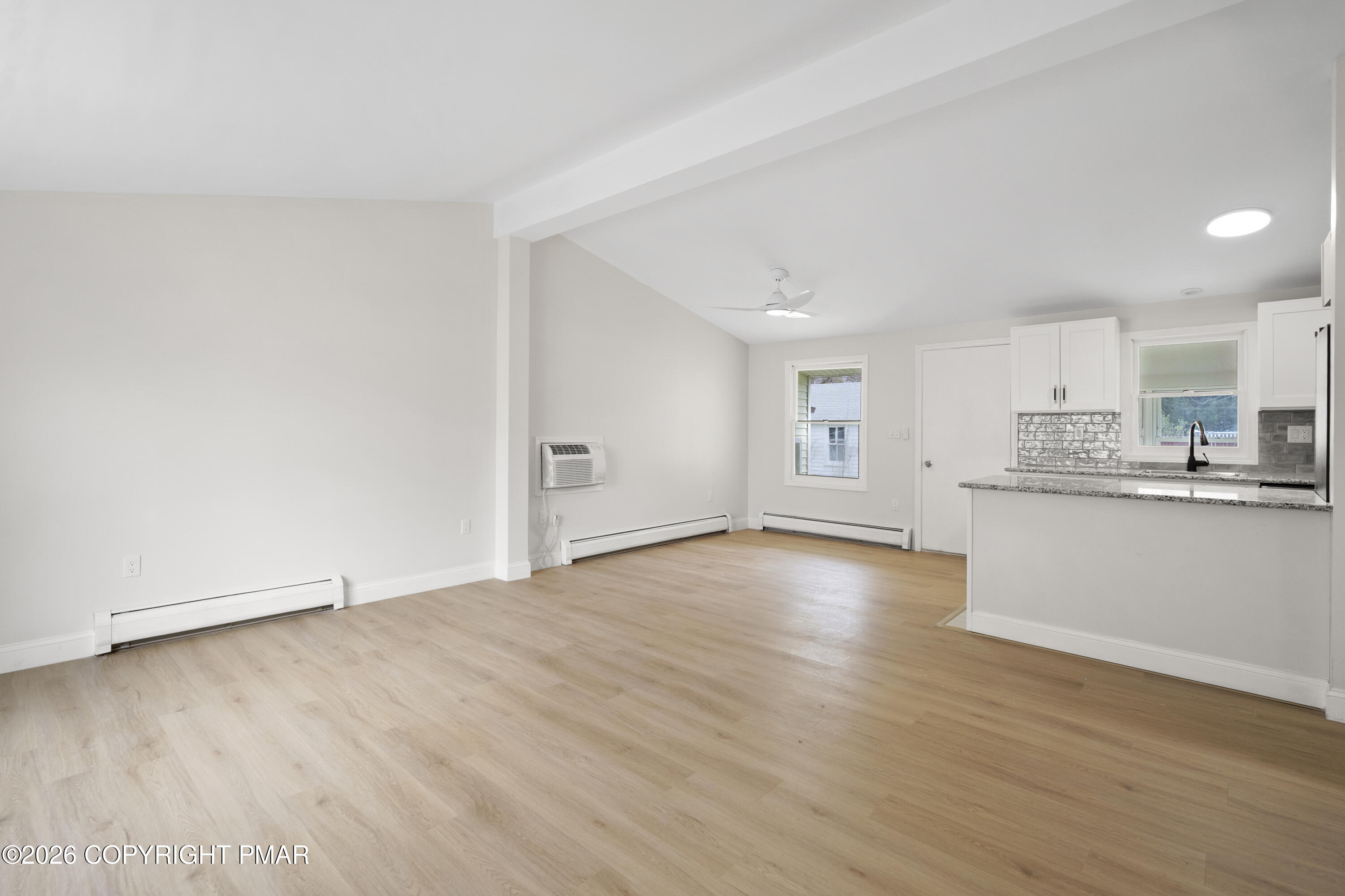605 5th Street Matamoras, PA 18336 - Photo 5 of 27 a view of empty room with wooden floor and kitchen