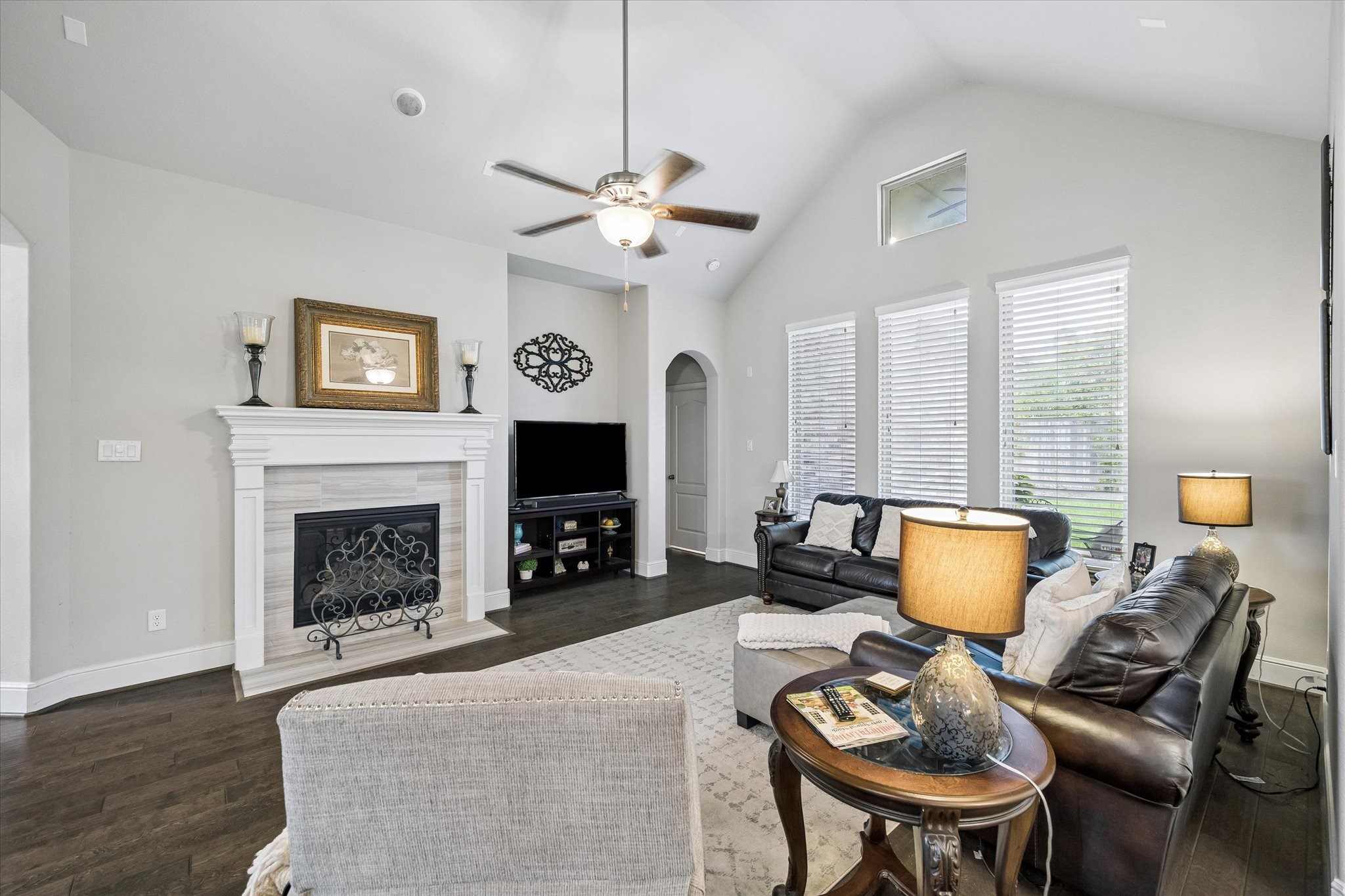 19 Peace Tree Way Tomball, TX 77375 - Photo 14 of 36 Cozy gaslog fireplace with elegant tile surround highlights the den.