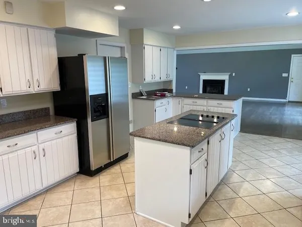 a view of empty room with wooden floor and fireplace