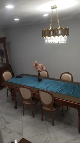 a room with table chairs and wooden floor