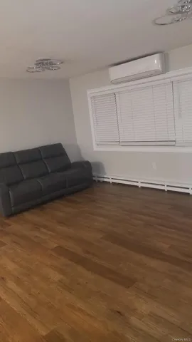 a living room with hard wood floors