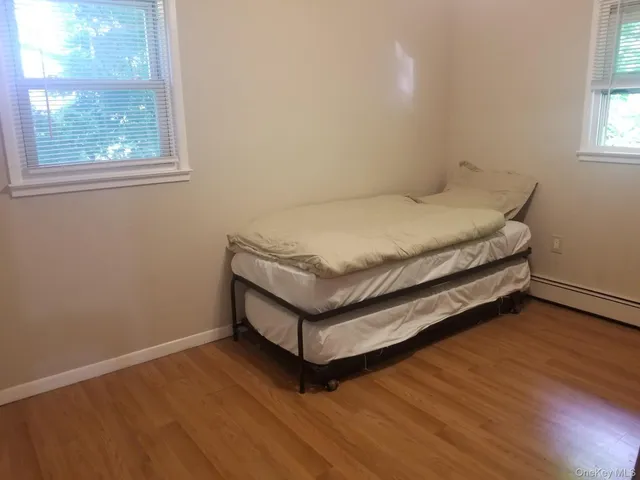 a bed sitting in a bedroom next to a window