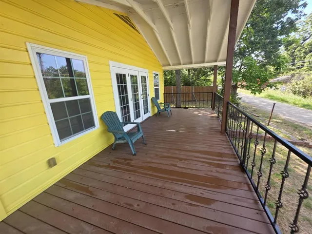 a view of a deck with wooden floor and outdoor seating
