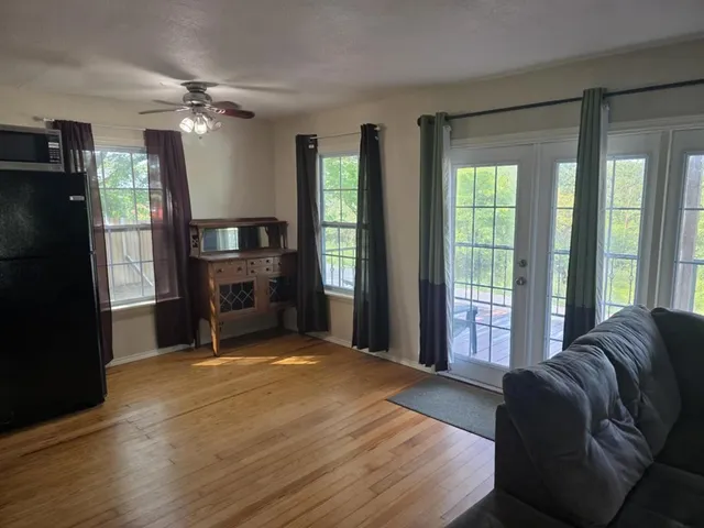 a spacious bedroom with a bed and a large window