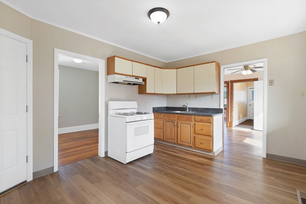 86-88 Chestnut Street Springfield, MA 01151 - Photo 12 of 40 a kitchen with granite countertop white cabinets and white appliances