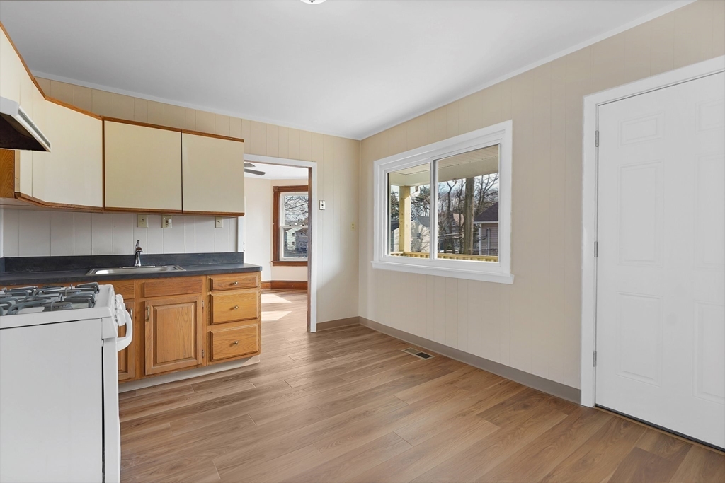 86-88 Chestnut Street Springfield, MA 01151 - Photo 13 of 40 a kitchen with granite countertop wooden floors and white stainless steel appliances