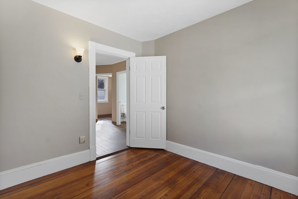 86-88 Chestnut Street Springfield, MA 01151 - Photo 17 of 40 a view of an empty room with wooden floor and closet