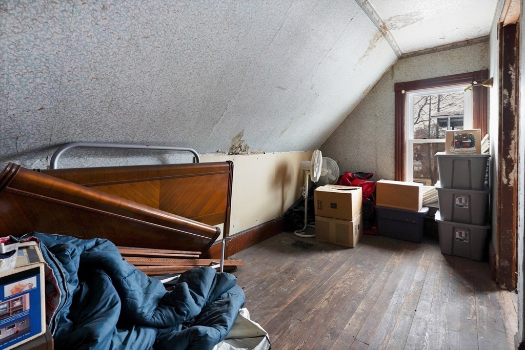 86-88 Chestnut Street Springfield, MA 01151 - Photo 22 of 40 a bedroom with a bed and a chair