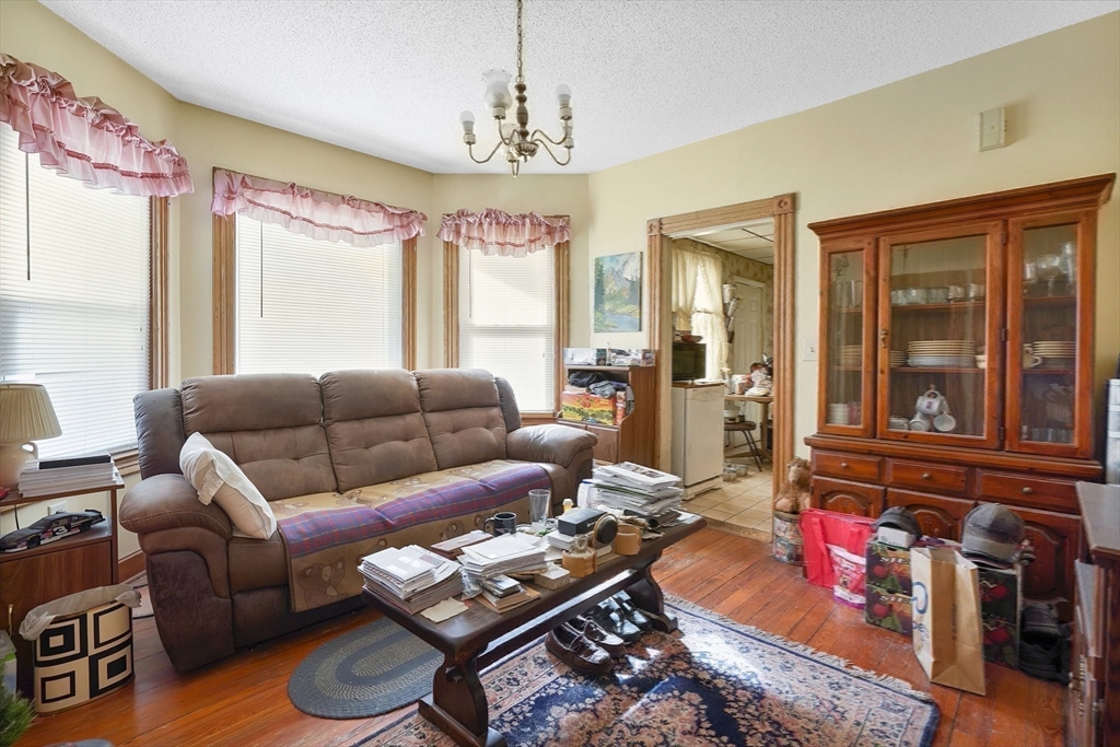 86-88 Chestnut Street Springfield, MA 01151 - Photo 27 of 40 a living room with furniture and a chandelier