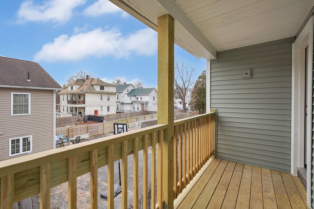 86-88 Chestnut Street Springfield, MA 01151 - Photo 36 of 40 a view of a balcony with wooden floor and fence