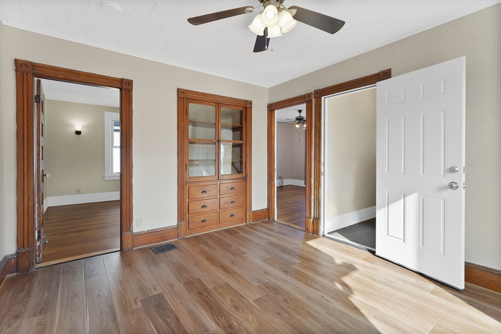 86-88 Chestnut Street Springfield, MA 01151 - Photo 4 of 40 an empty room with wooden floor chandelier and windows