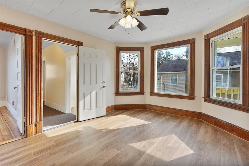 86-88 Chestnut Street Springfield, MA 01151 - Photo 5 of 40 a view of an empty room with a window and wooden floor