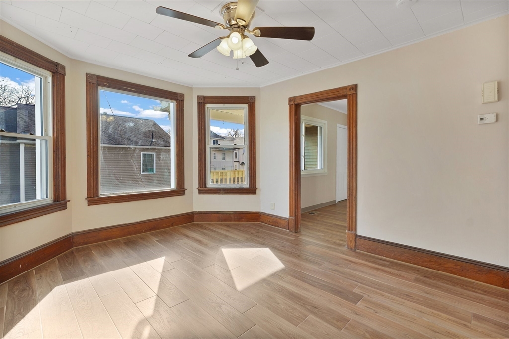 86-88 Chestnut Street Springfield, MA 01151 - Photo 6 of 40 a view of an empty room with window and wooden floor