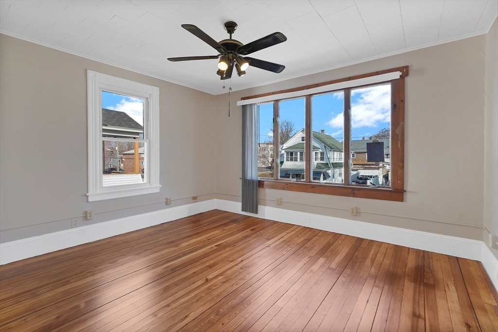 86-88 Chestnut Street Springfield, MA 01151 - Photo 7 of 40 a view of an empty room with wooden floor and a window
