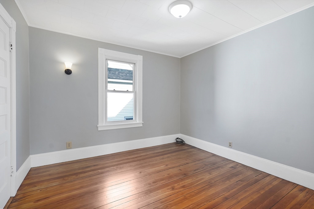 86-88 Chestnut Street Springfield, MA 01151 - Photo 9 of 40 a view of empty room with wooden floor and fan