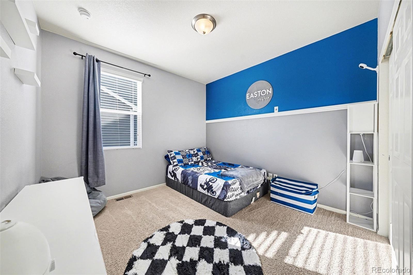 910 Pierson Court Windsor, CO 80550 - Photo 20 of 42 a bedroom with a bed and a table