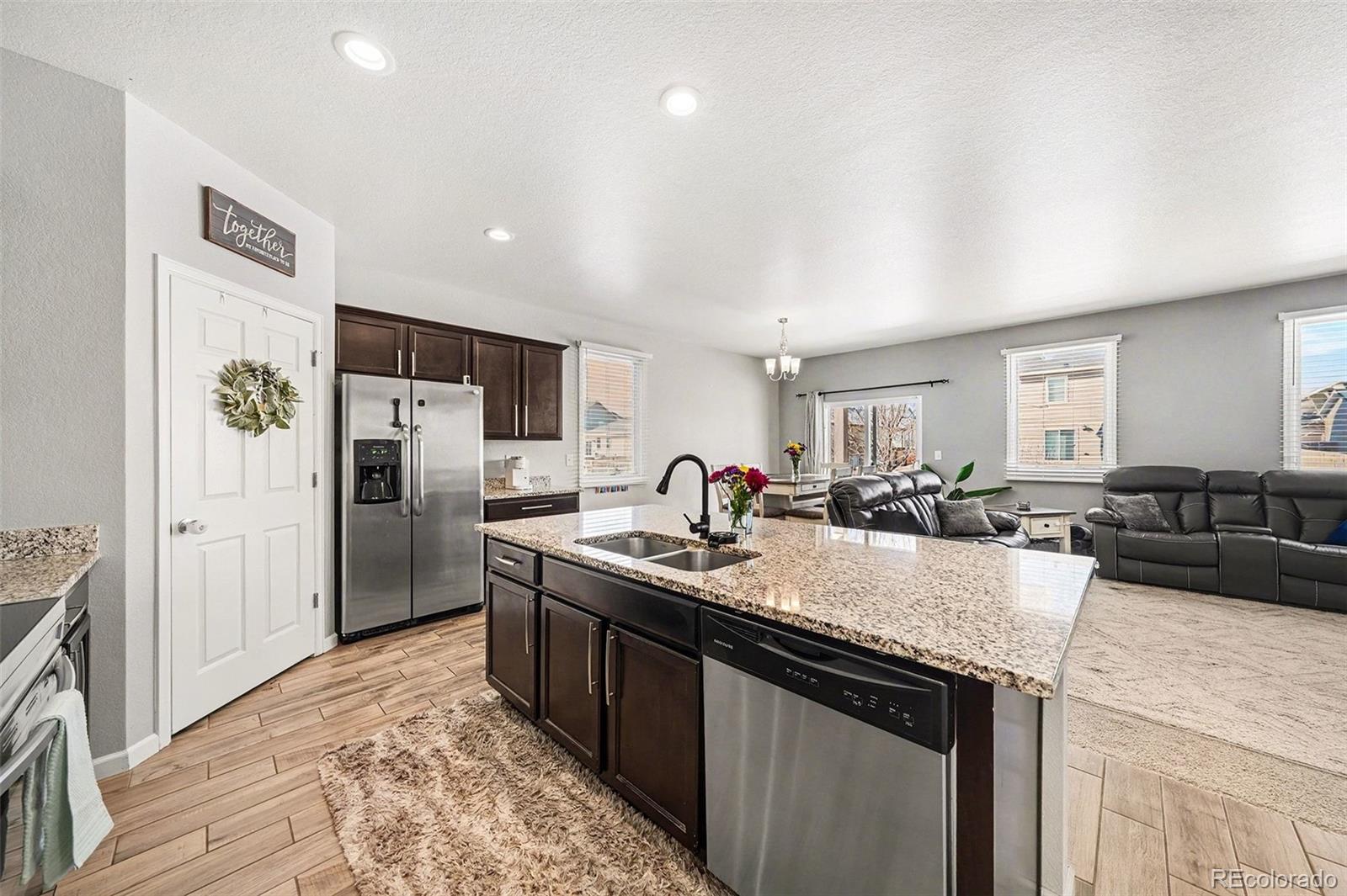 910 Pierson Court Windsor, CO 80550 - Photo 8 of 42 a kitchen with refrigerator and cabinets