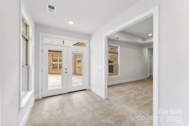 an empty room with windows and closet