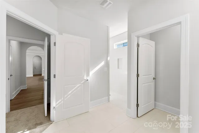 a view of a hallway with closet and wooden floor