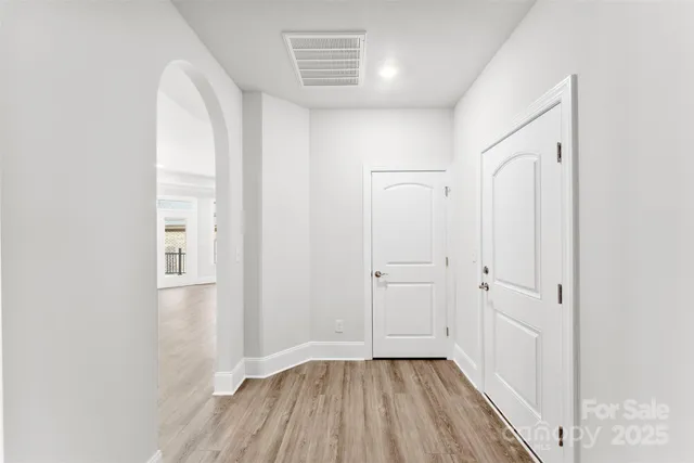a view of a room with wooden floor and window