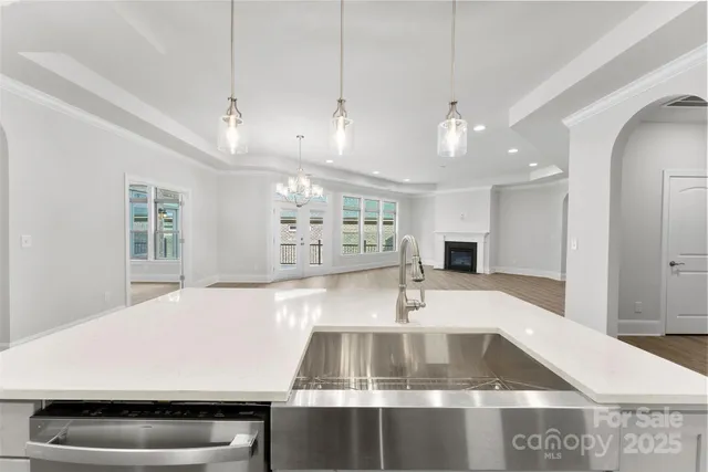 a view of kitchen with a sink and a refrigerator