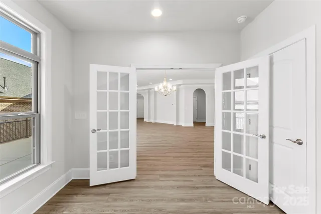 a view of a hallway with wooden floor and entryway