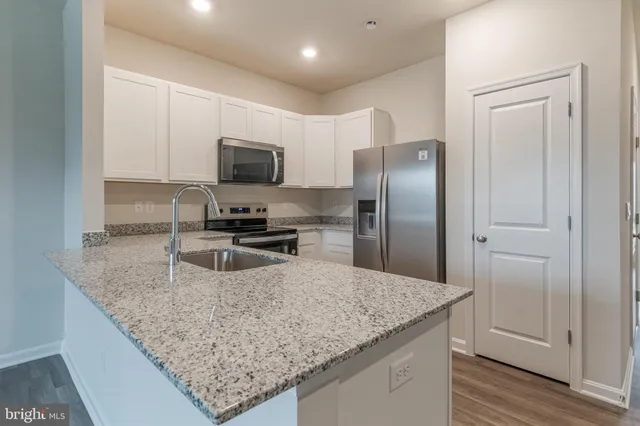 a kitchen with granite countertop counter top space cabinets and stainless steel appliances