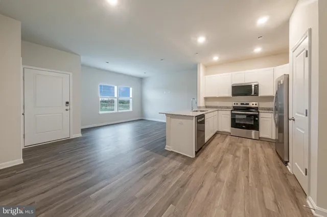 a view of kitchen with sink microwave and refrigerator