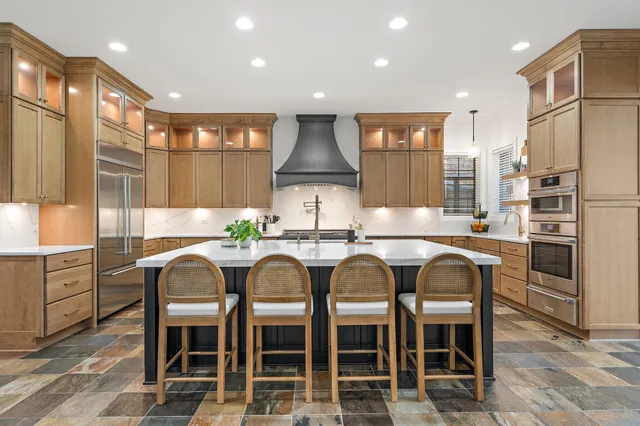 a view of a dining room with furniture a chandelier and wooden floor