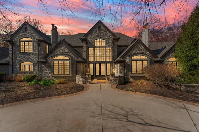 a view of a hallway view with staircase and kitchen view