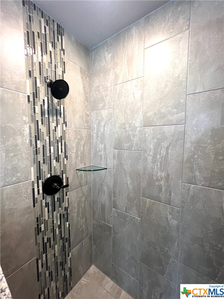 3827 Leming Court Temple, TX 76504 - Photo 7 of 14 a bathroom with a shower and a mirror